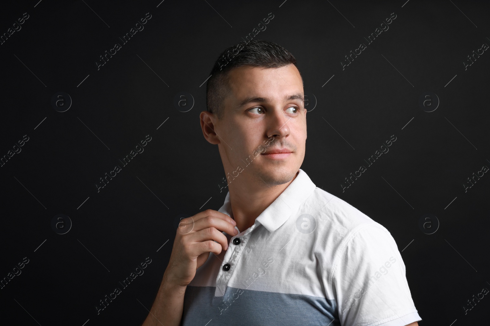 Photo of Portrait of handsome man on black background