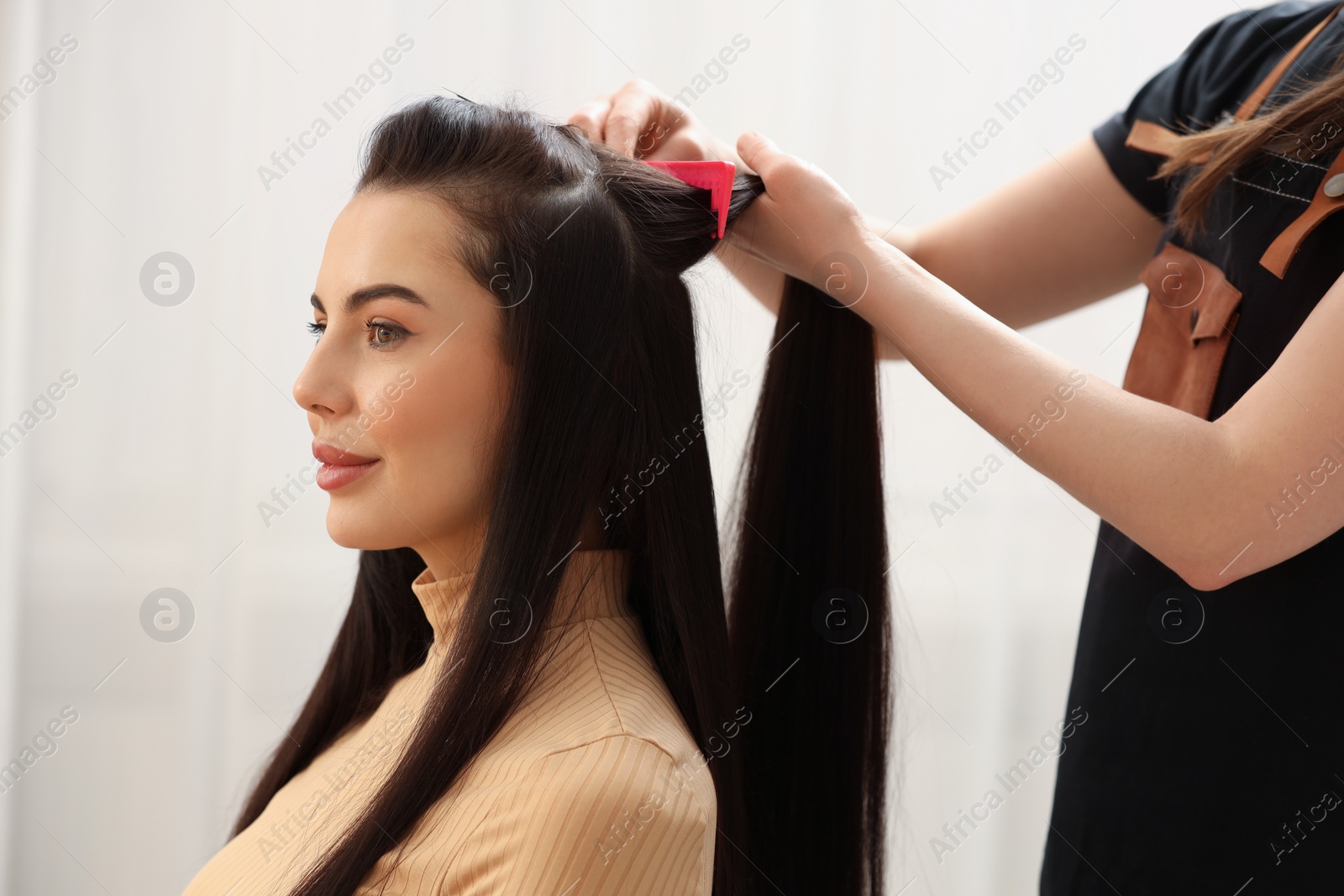 Photo of Hair styling. Professional hairdresser working with client in salon, closeup