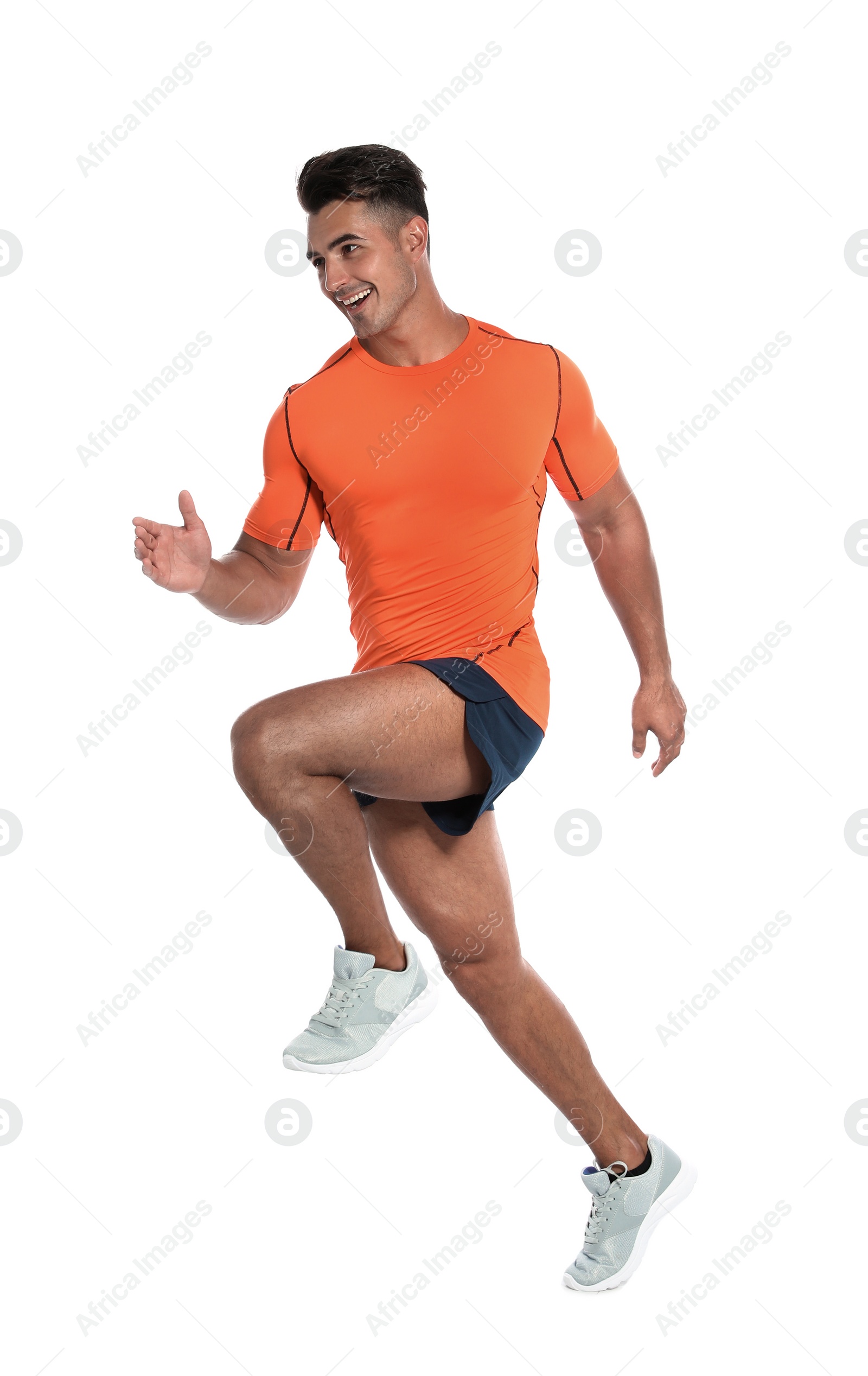 Photo of Handsome young man running on white background