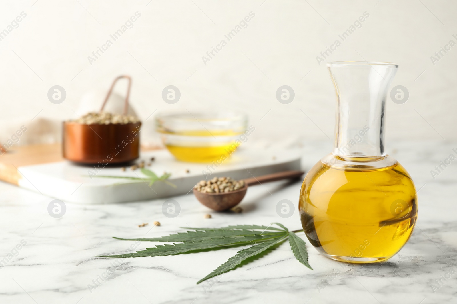 Photo of Composition with hemp oil on marble table