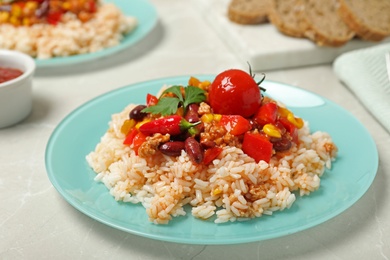 Photo of Chili con carne served with rice on table