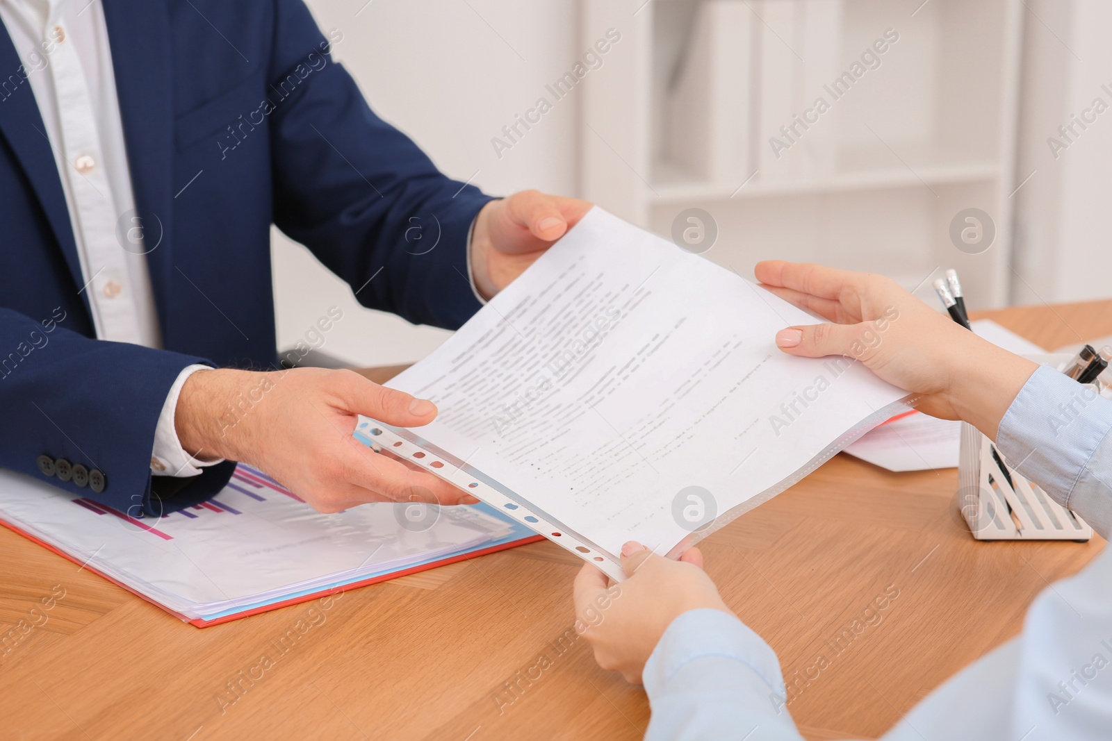 Photo of Businesspeople working with documents at wooden table in office, closeup