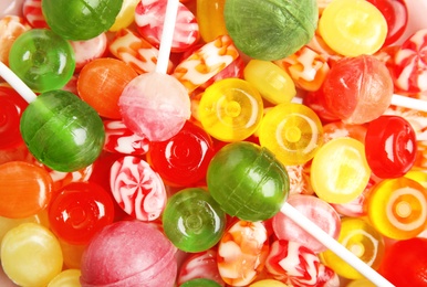 Photo of Different delicious colorful candies as background, top view