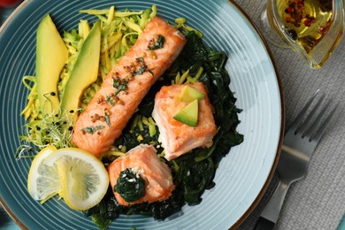 Photo of Tasty salmon with spinach served on table, flat lay