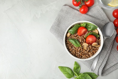 Flat lay composition with delicious buckwheat porridge on table, space for text