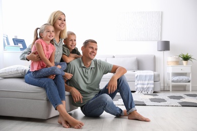 Photo of Happy family with children in living room