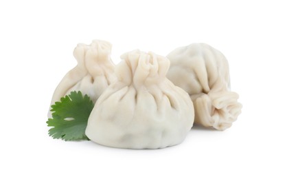 Photo of Three tasty khinkali (dumplings) and parsley isolated on white. Georgian cuisine