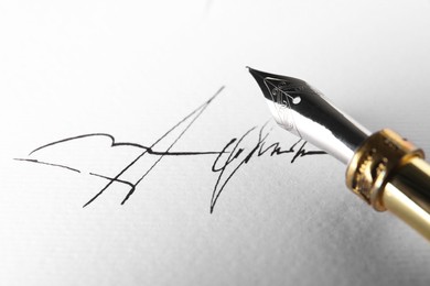 Photo of Sheet of paper with fountain pen and signature, closeup