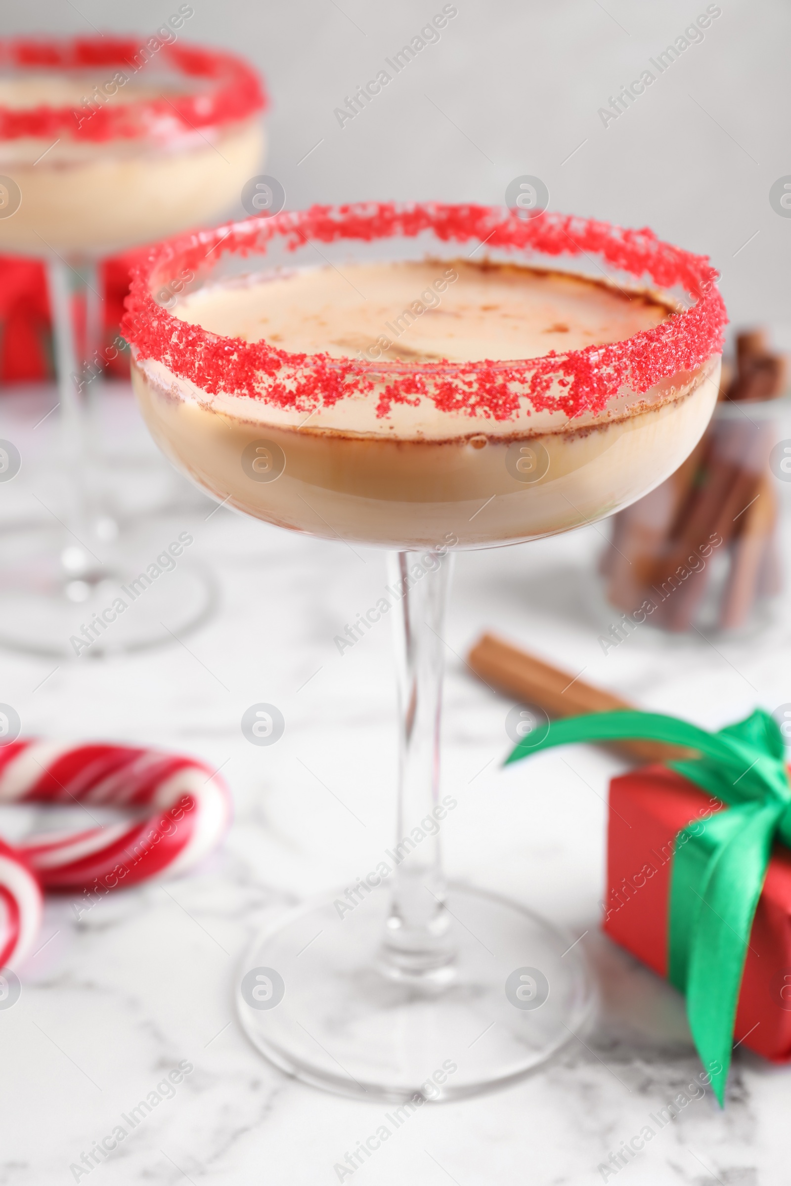 Photo of Delicious Christmas liqueur on white marble table, closeup