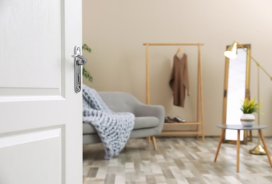 Photo of Stylish room interior, view through open door