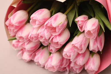 Beautiful bouquet of fresh pink tulips on light background, closeup