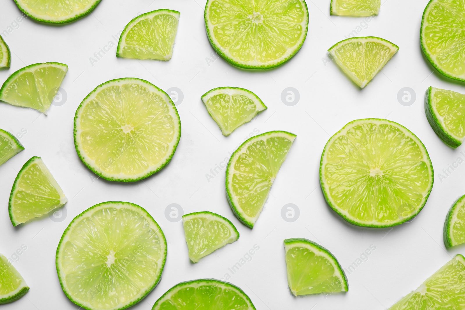 Photo of Juicy fresh lime slices on white background, top view