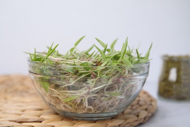 Photo of Mung bean sprouts in glass bowl on table, closeup