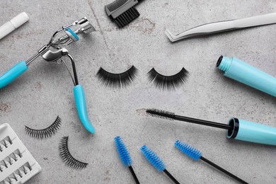 Photo of Flat lay composition with false eyelashes and tools on light grey background