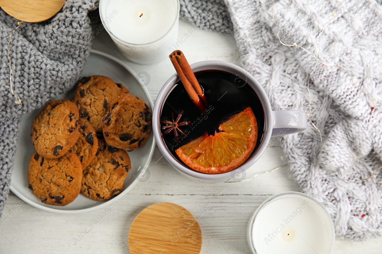 Photo of Flat lay composition with cup of hot mulled wine on white wooden table. Winter drink