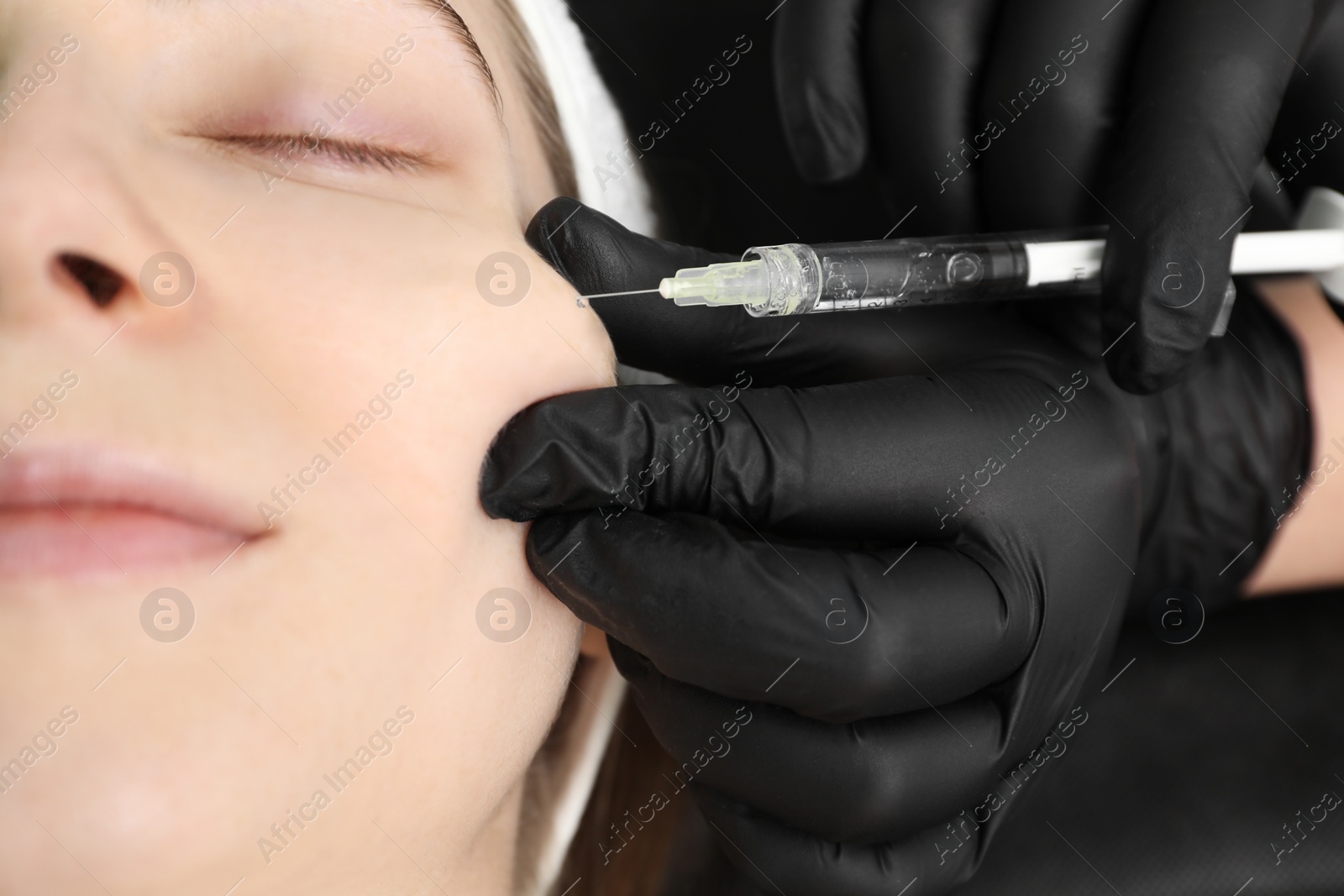 Photo of Cosmetologist giving facial injection to patient, closeup. Cosmetic surgery