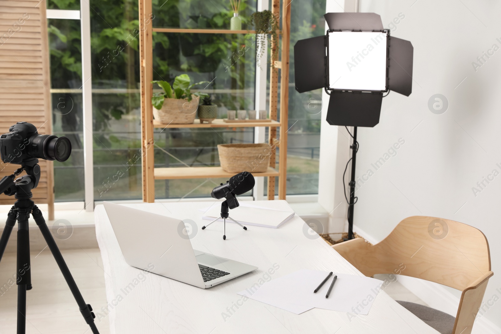 Photo of Modern blogger's workplace with professional equipment and laptop in room