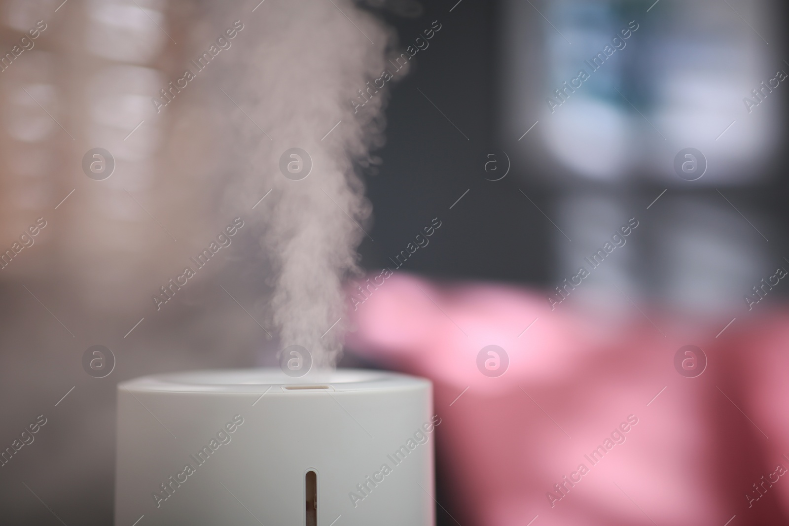 Photo of Modern air humidifier indoors, closeup. Space for text