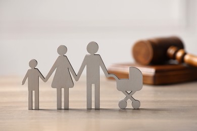 Photo of Family law. Figure of parents with children and gavel on wooden table