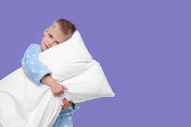 Photo of Sleepy boy with pillow on purple background, space for text. Insomnia problem