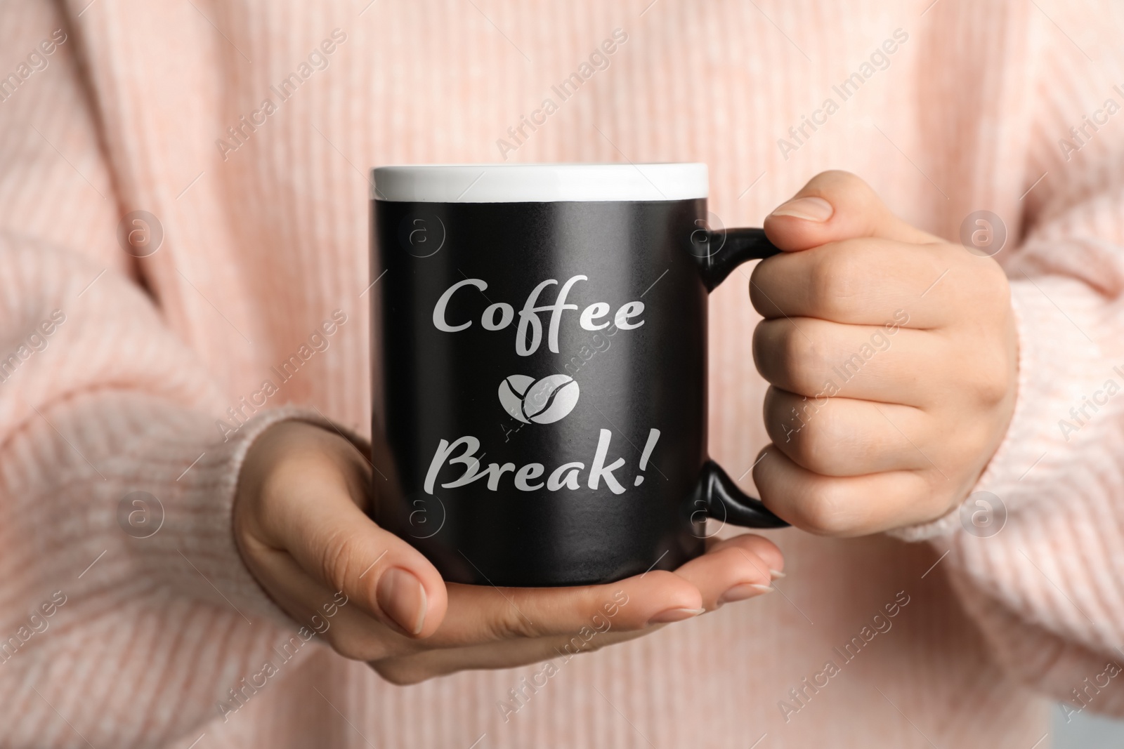 Image of Woman holding mug with inscription Coffee Break, closeup