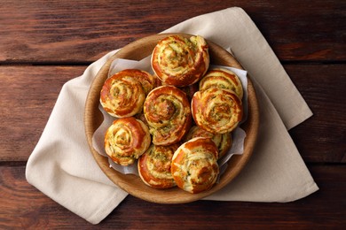 Fresh delicious puff pastry with tasty filling on wooden table, top view