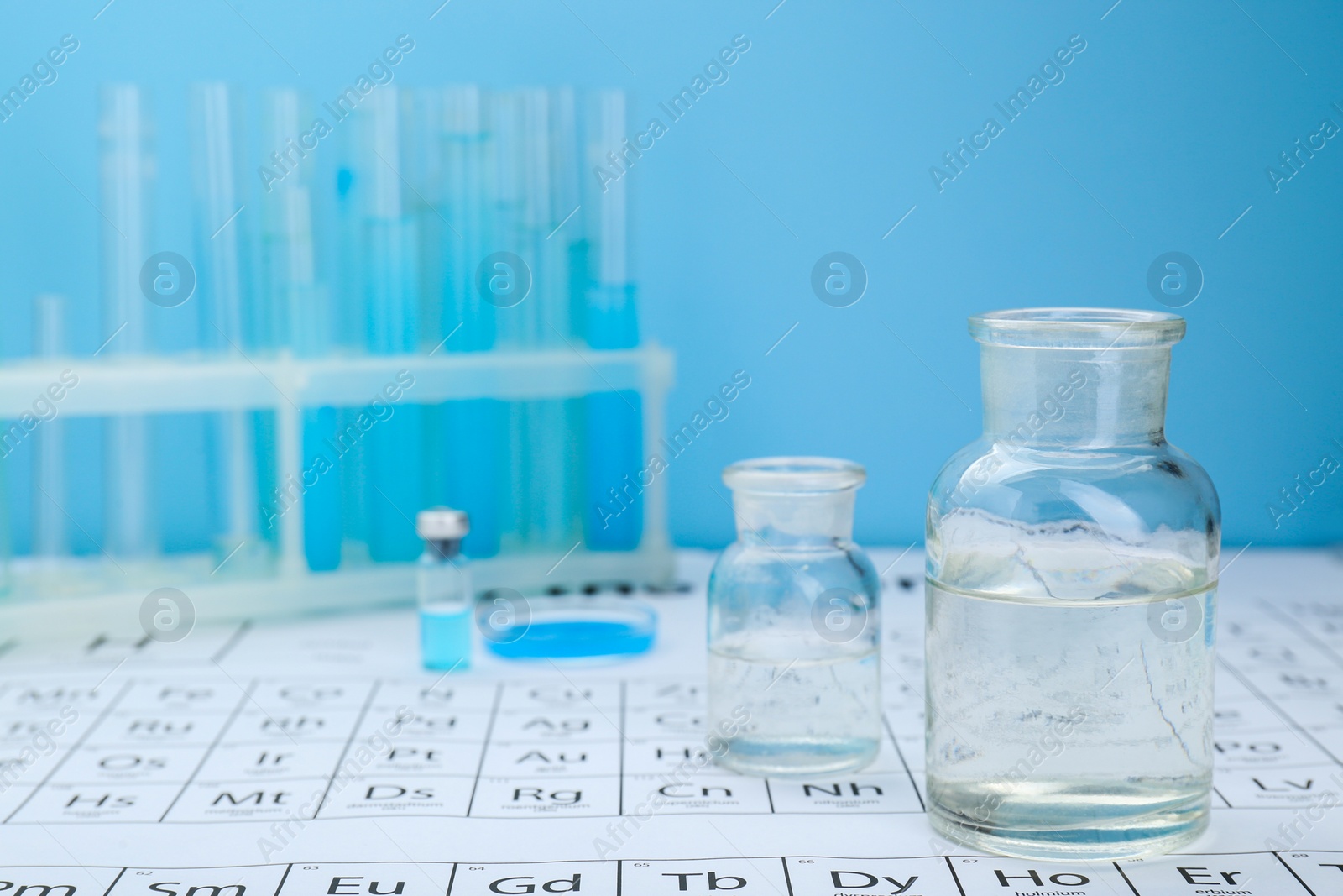 Photo of Bottles on periodic table of chemical elements. Space for text