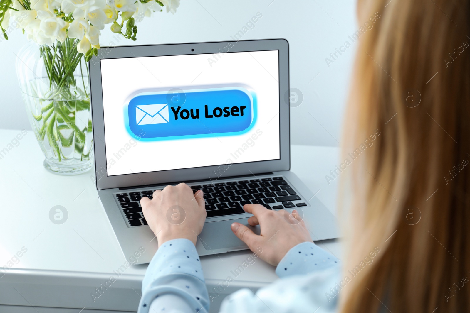 Image of Young woman using laptop at white table, closeup. Cyber bullying