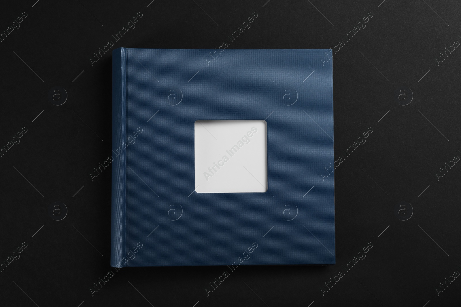 Photo of One photo album on black background, top view