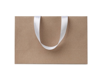 Photo of Paper shopping bag with ribbon handles on white background. Mockup for design