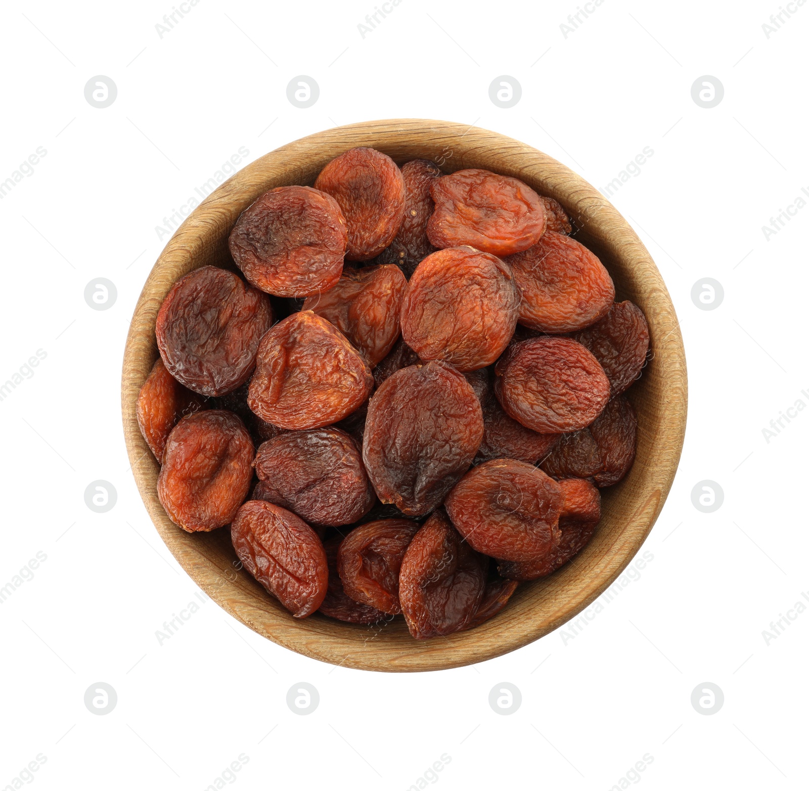 Photo of Wooden bowl with dried tasty apricots isolated on white, top view