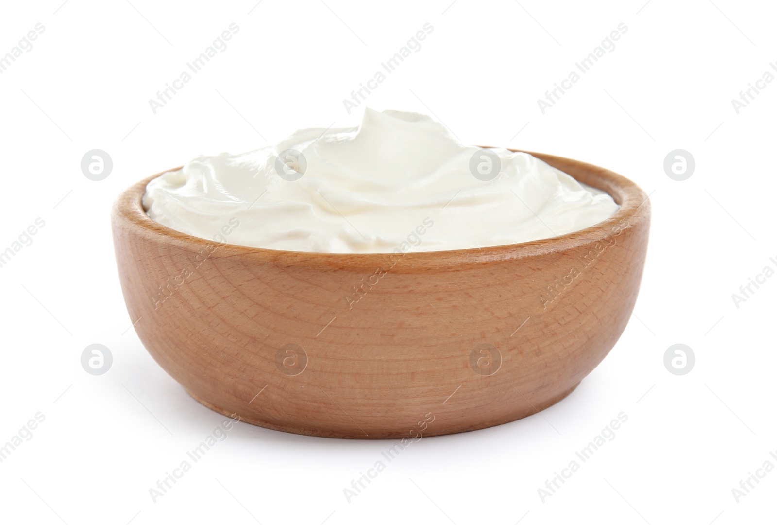 Photo of Wooden bowl with fresh sour cream isolated on white