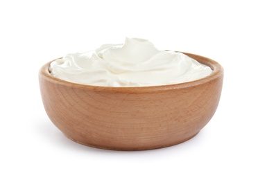 Photo of Wooden bowl with fresh sour cream isolated on white