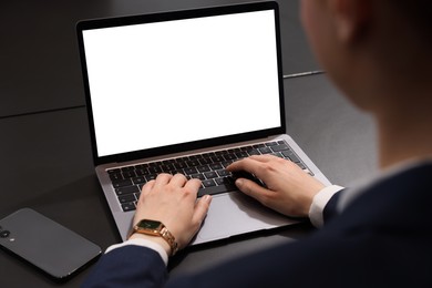 Photo of Woman working with laptop at black desk, closeup