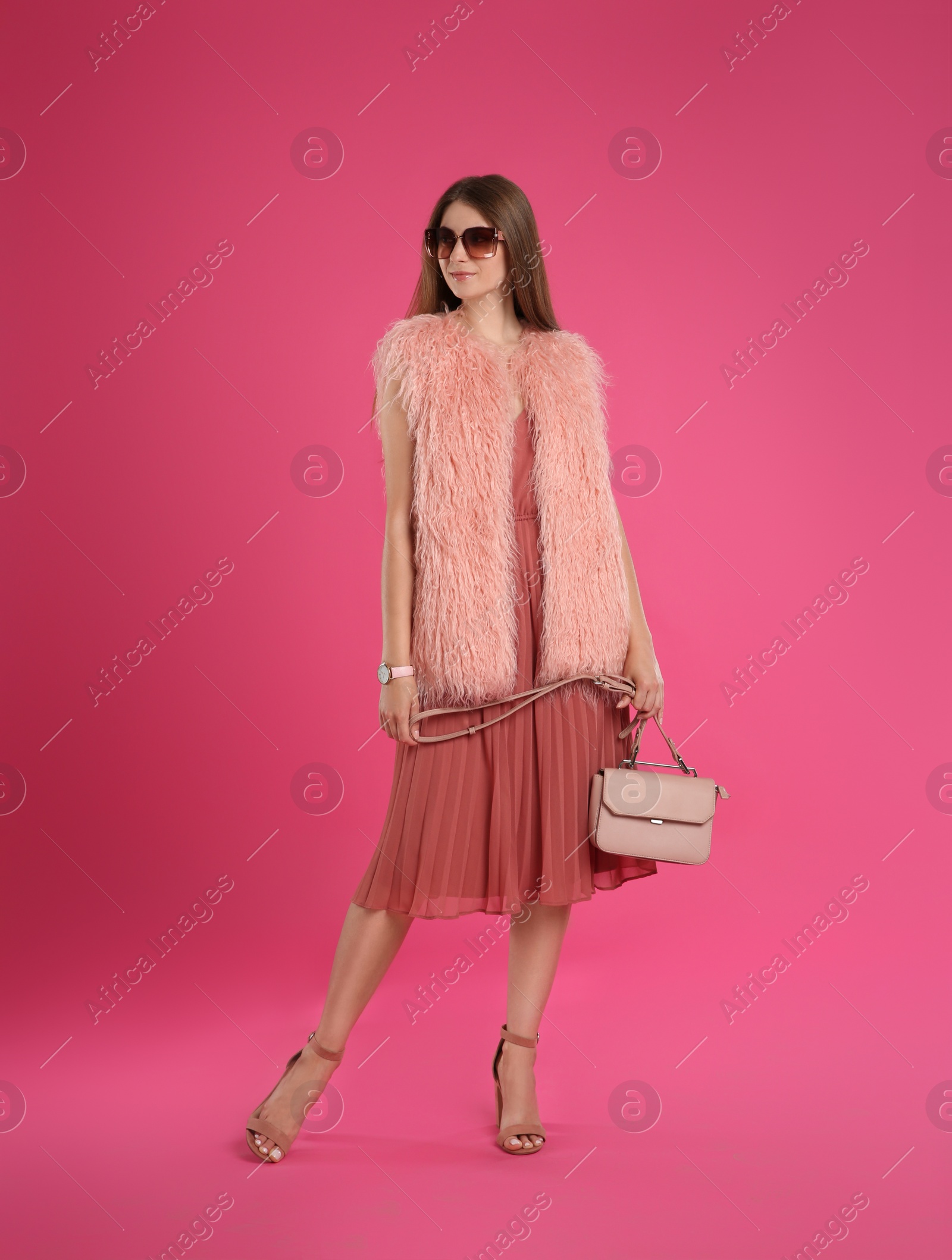 Photo of Beautiful young woman with stylish bag on pink background