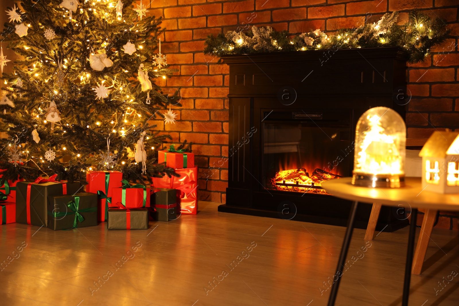 Photo of Beautifully wrapped gift boxes under Christmas tree in living room