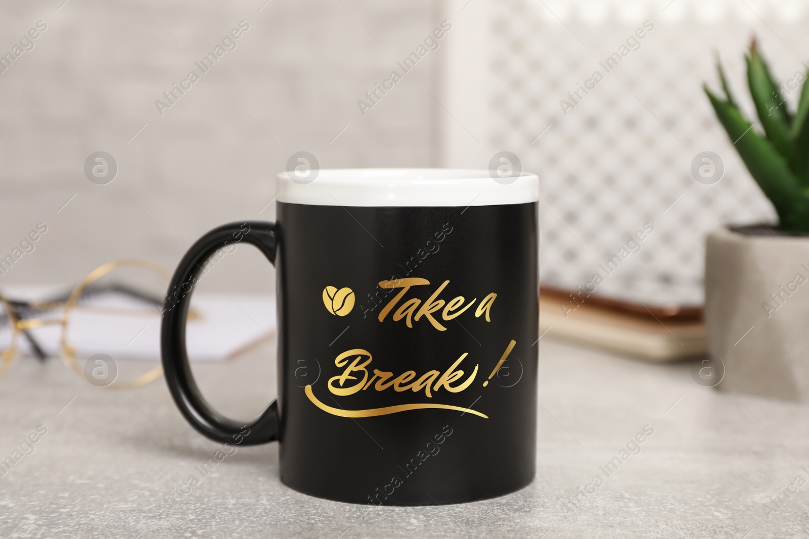 Image of Cup of coffee with inscription Take a Break on grey table