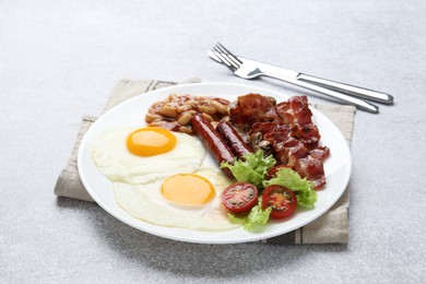 Photo of Delicious breakfast with sunny side up eggs on light table