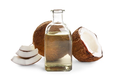 Photo of Ripe coconuts and bottle with natural organic oil on white background