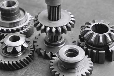 Photo of Different stainless steel gears on background, closeup