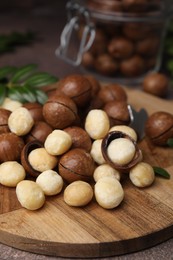 Tasty organic Macadamia nuts on grey table, closeup