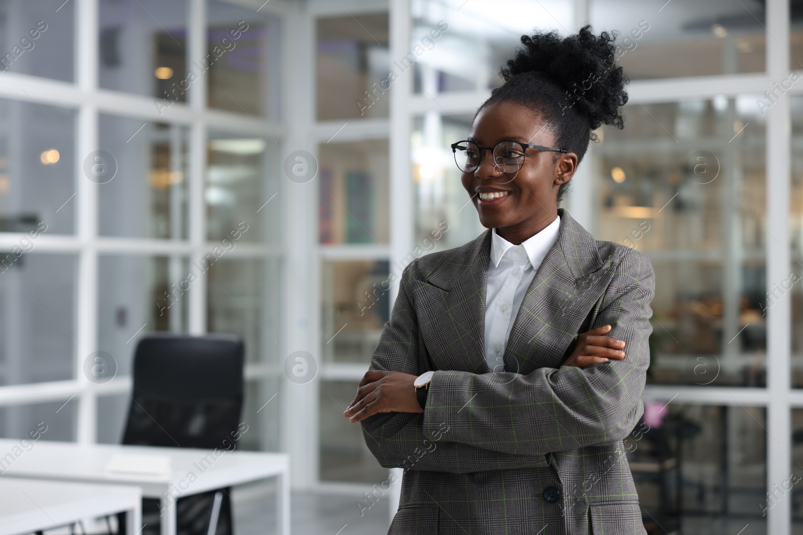 Photo of Happy woman with crossed arms in office, space for text. Lawyer, businesswoman, accountant or manager