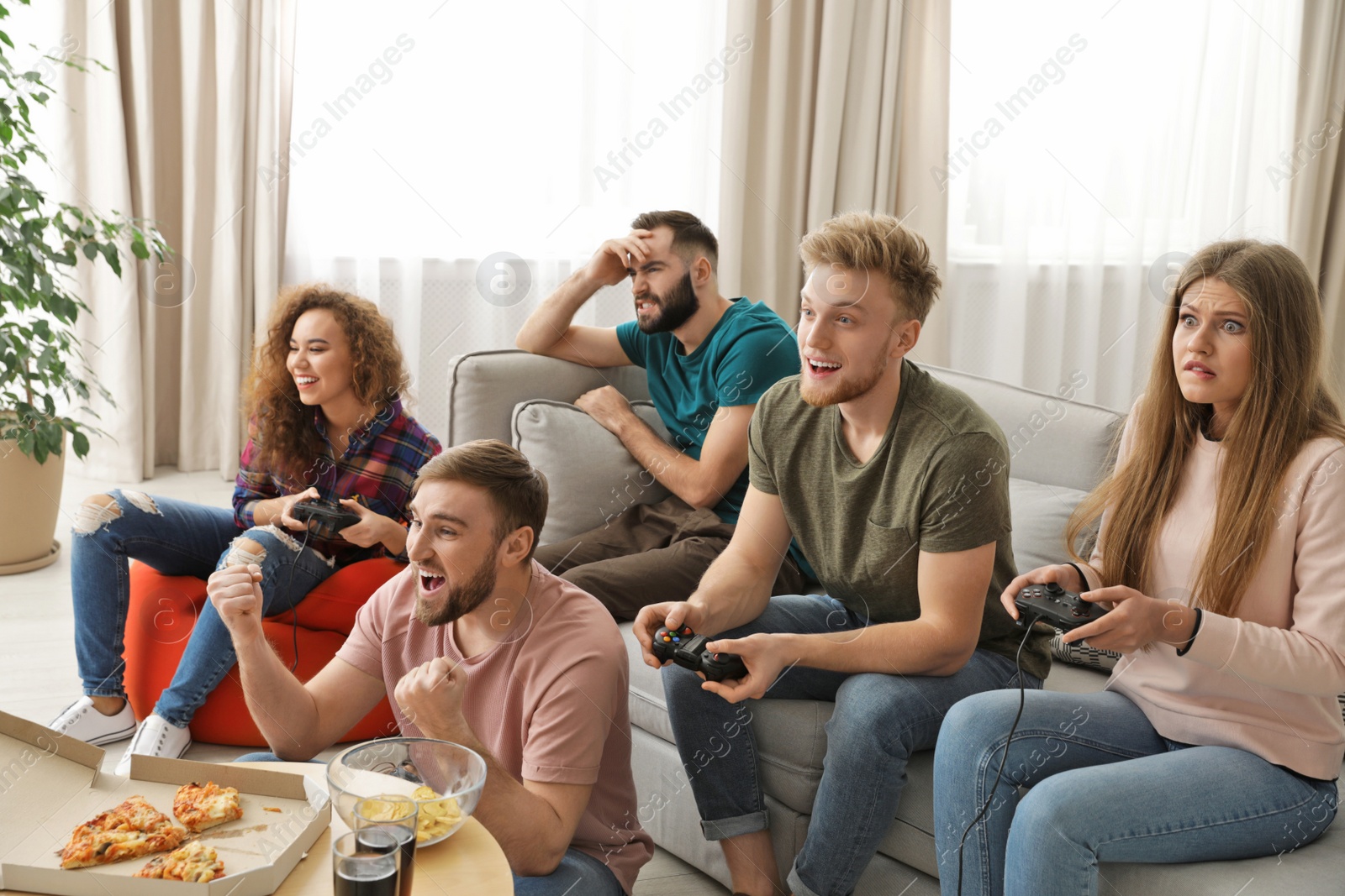 Photo of Emotional friends playing video games at home