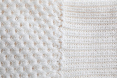 White knitted sweater as background, closeup view