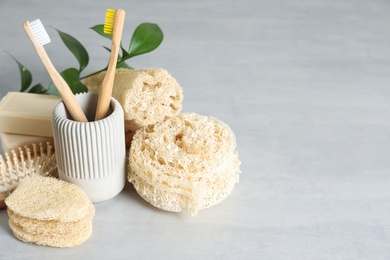 Photo of Composition with natural loofah sponges on table. Space for text