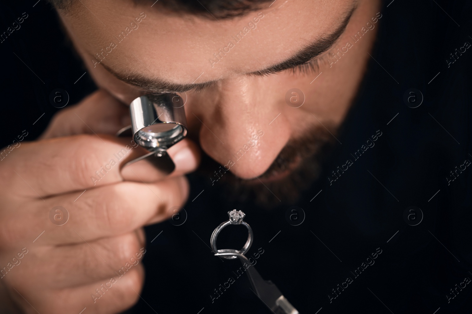 Photo of Professional jeweler working with ring, closeup view