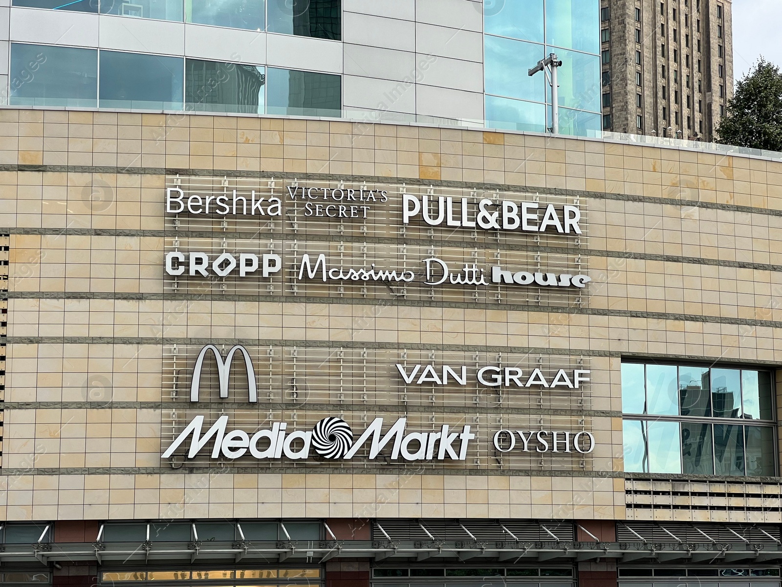 Photo of WARSAW, POLAND - JULY 17, 2022: Shopping mall with different store brand logos outdoors