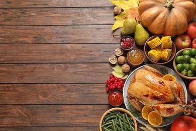 Photo of Flat lay composition with turkey on wooden background, space for text. Happy Thanksgiving day