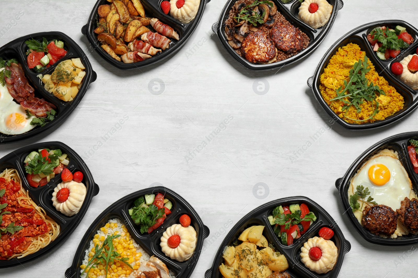 Photo of Frame made of lunchboxes on white table, top view with space for text. Healthy food delivery