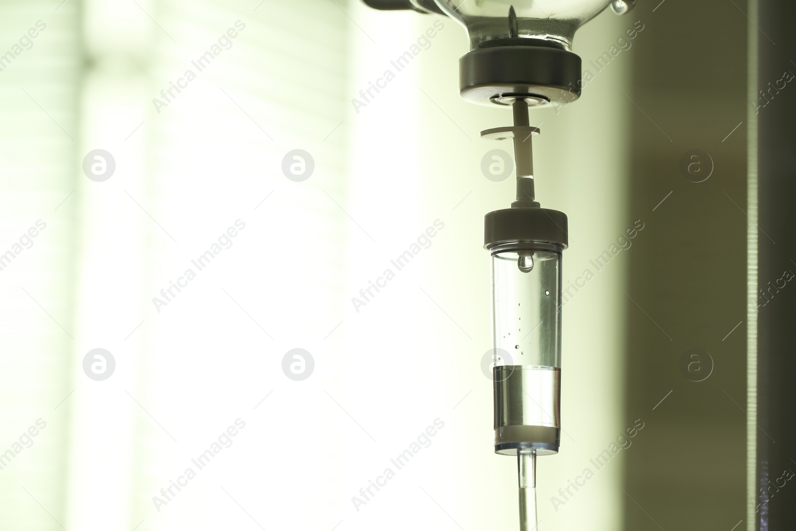 Photo of IV drip against blurred background, space for text